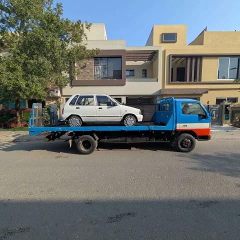 Flatbed tow truck transporting a vehicle safely